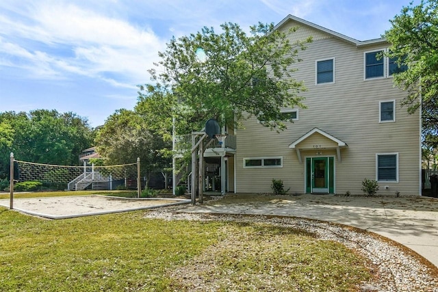 exterior space with a lawn and volleyball court