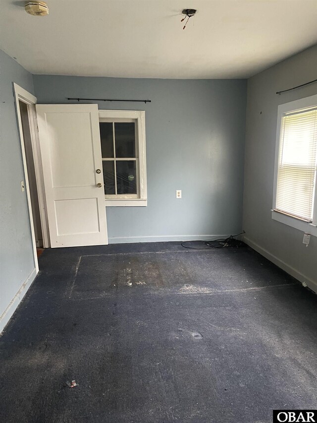 506 Poplar Branch Rd, Poplar Branch, NC 27965 - spare room featuring baseboards, carpet, and a smoke detector