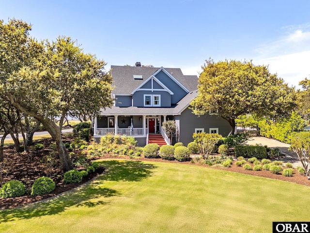 568 Live Oak Ct Lot # 82, Corolla, NC 27927 - view of front of property with covered porch, a front yard, roof with shingles, and a chimney