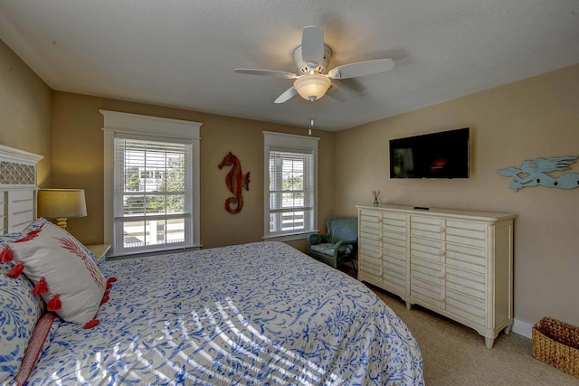 bedroom featuring baseboards, a ceiling fan, and light colored carpet