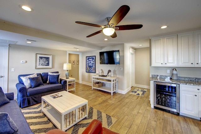 living room featuring wine cooler, recessed lighting, a ceiling fan, baseboards, and light wood finished floors