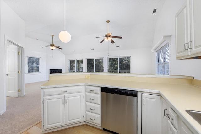 kitchen with ceiling fan, white cabinets, vaulted ceiling, light countertops, and stainless steel dishwasher