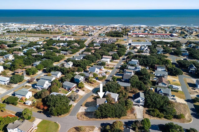 drone / aerial view with a water view and a residential view