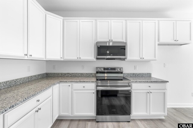 104 Yadkin Dr Lot # 77, South Mills, NC 27973 - kitchen featuring stainless steel appliances, white cabinets, and light stone counters