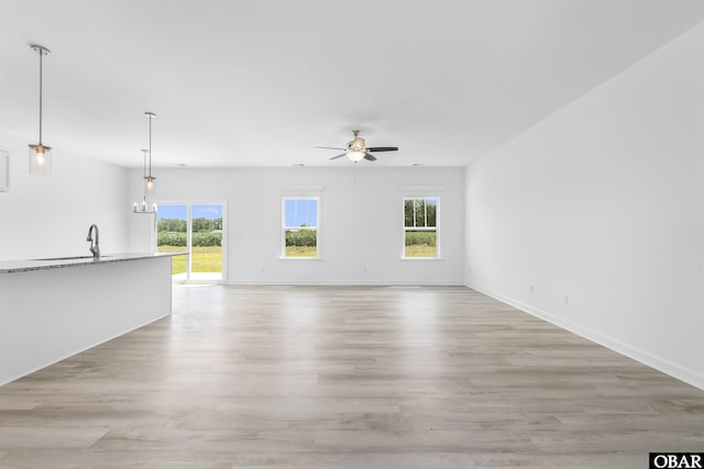 104 Yadkin Dr Lot # 77, South Mills, NC 27973 - unfurnished living room with healthy amount of natural light, a ceiling fan, and light wood-style floors