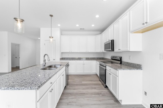 104 Yadkin Dr Lot # 77, South Mills, NC 27973 - kitchen with appliances with stainless steel finishes, recessed lighting, white cabinetry, light stone countertops, and hanging light fixtures