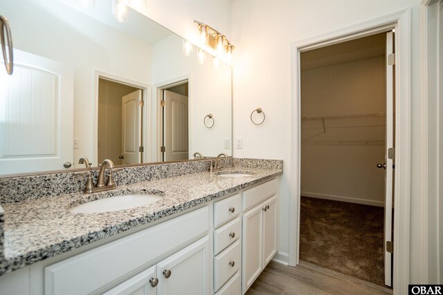 104 Yadkin Dr Lot # 77, South Mills, NC 27973 - bathroom featuring double vanity, wood finished floors, and a walk in closet