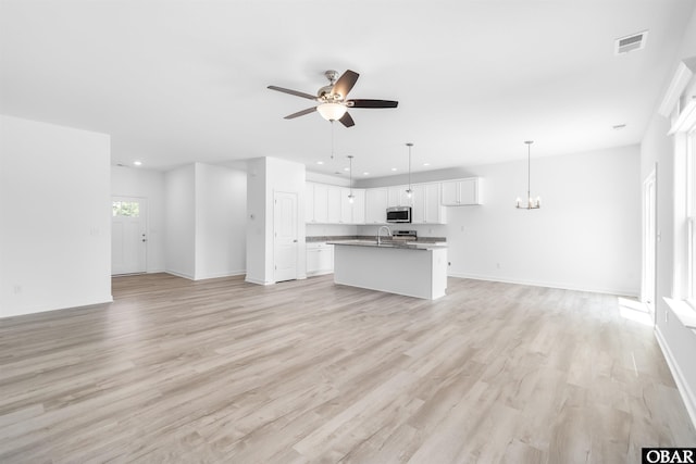 104 Yadkin Dr Lot # 77, South Mills, NC 27973 - unfurnished living room with ceiling fan, light wood-type flooring, a chandelier, and recessed lighting