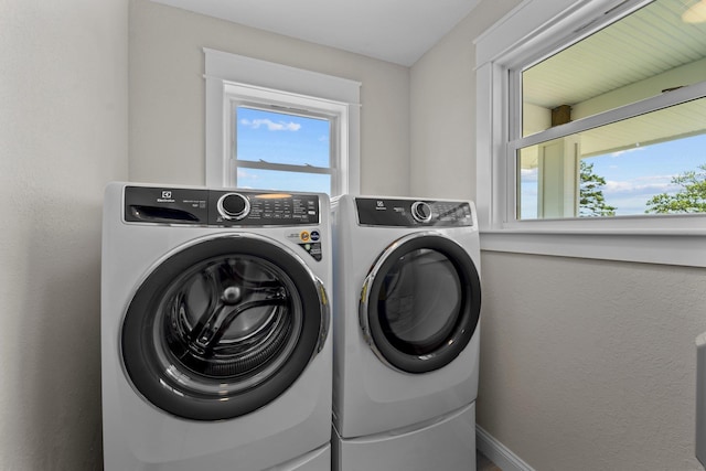 laundry room featuring laundry area, plenty of natural light, and independent washer and dryer