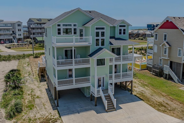 56738 NC-12 Hwy Lot 5, Hatteras, NC 27943 - back of house with concrete driveway, roof with shingles, and a carport