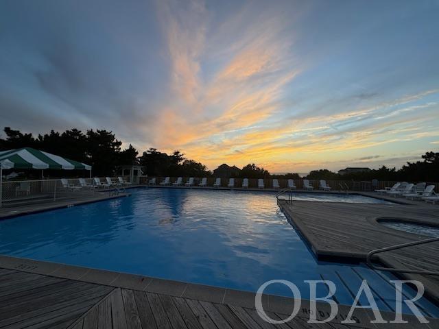 pool at dusk with a community pool