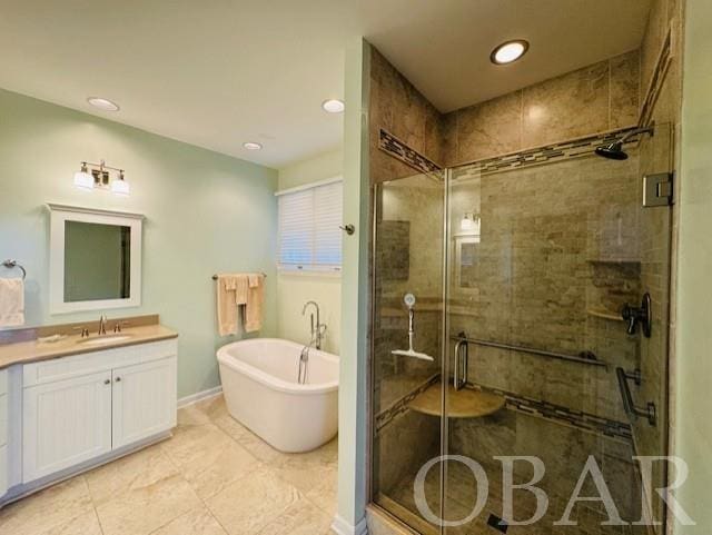 full bath with a stall shower, a freestanding tub, vanity, and recessed lighting