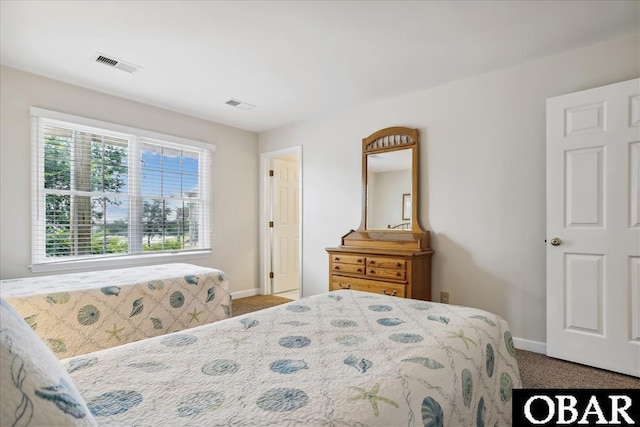 bedroom with carpet flooring, visible vents, and baseboards