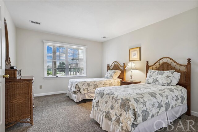 carpeted bedroom featuring baseboards and visible vents