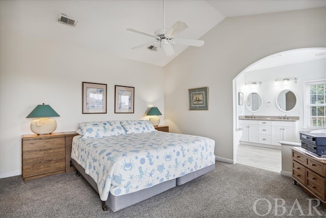 bedroom with visible vents, a sink, light carpet, and baseboards