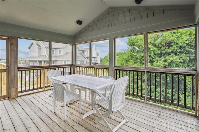 sunroom featuring a healthy amount of sunlight and vaulted ceiling