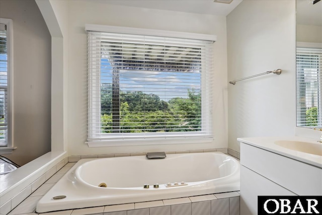 full bath with a garden tub and vanity