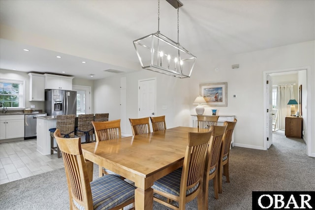 dining area featuring a chandelier, visible vents, light colored carpet, and recessed lighting