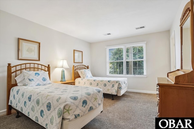 carpeted bedroom featuring baseboards and visible vents