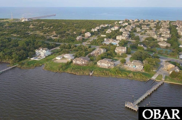 drone / aerial view featuring a residential view and a water view