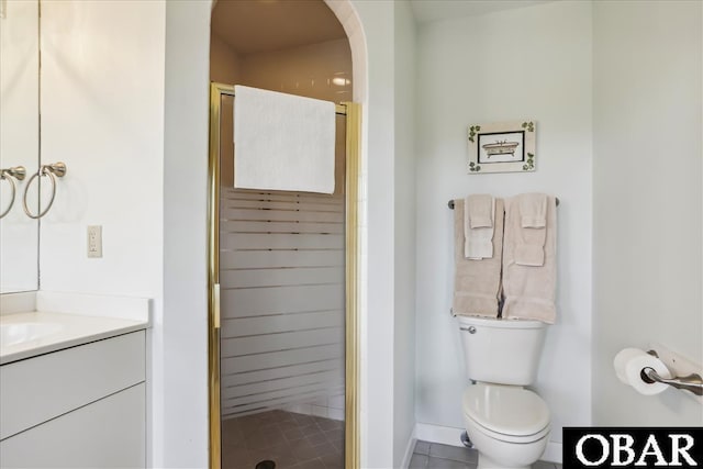 full bath featuring a stall shower, vanity, and toilet