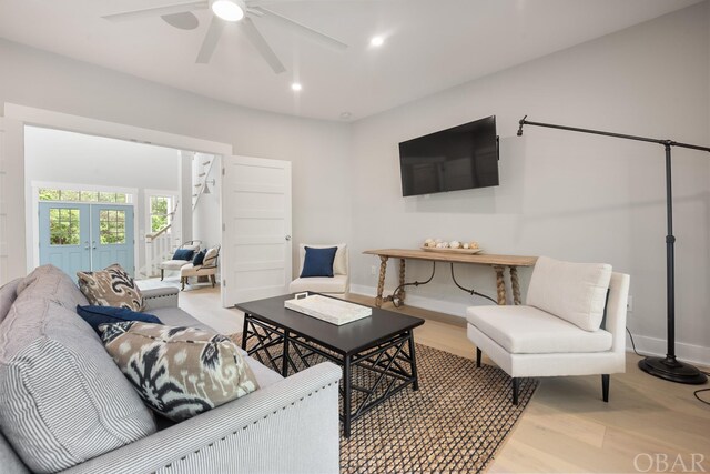 living room featuring baseboards, recessed lighting, a ceiling fan, and light wood-style floors