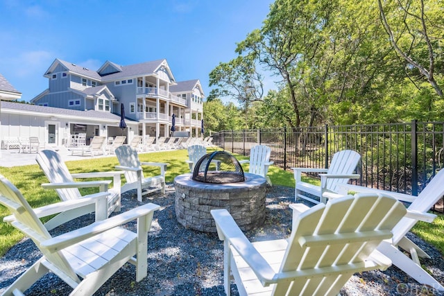 view of patio with an outdoor fire pit and fence