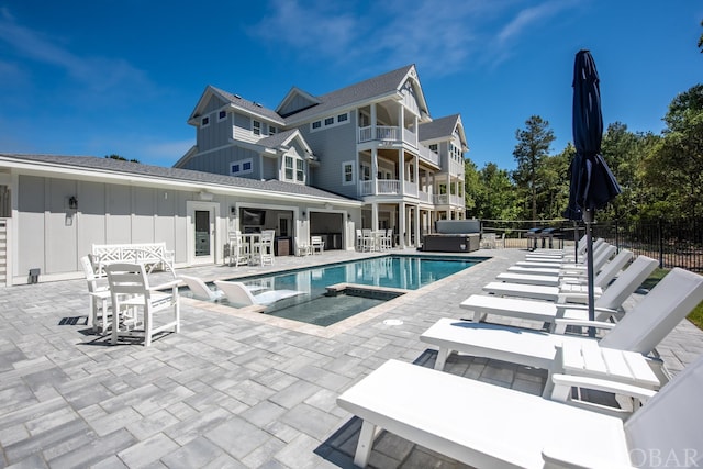 view of pool featuring an outdoor hot tub, fence, a fenced in pool, and a patio