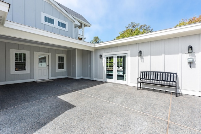 property entrance featuring a patio, french doors, and board and batten siding