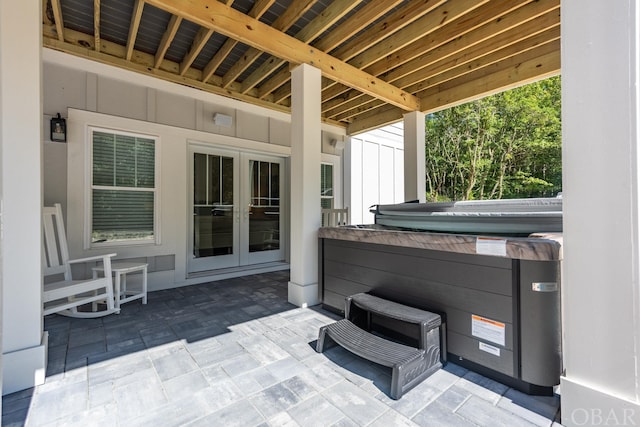 view of patio / terrace with a hot tub and french doors