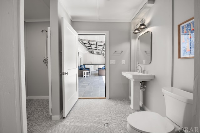 bathroom with baseboards and toilet