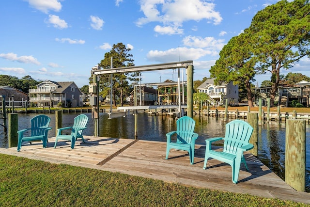 view of dock featuring a water view and a residential view