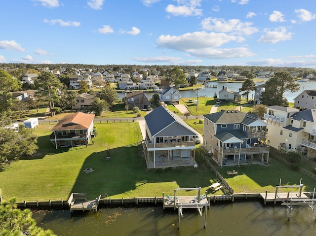 drone / aerial view featuring a water view and a residential view