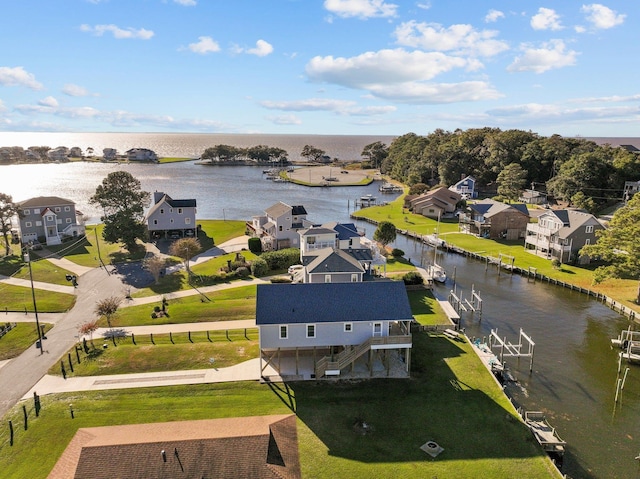 drone / aerial view featuring a water view and a residential view