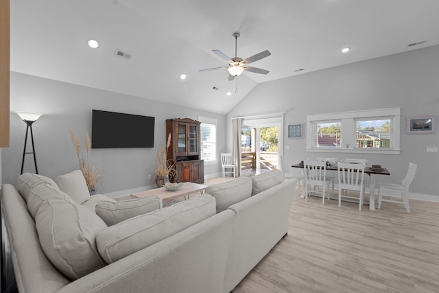 living area featuring light wood-style floors, lofted ceiling, visible vents, and recessed lighting