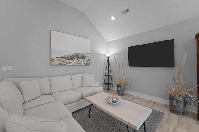 living room with vaulted ceiling, light wood-type flooring, visible vents, and baseboards