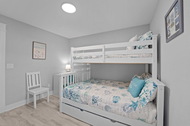 bedroom featuring light wood-style flooring and baseboards