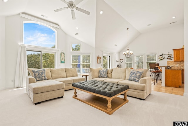 living room with high vaulted ceiling, light tile patterned floors, visible vents, and light carpet