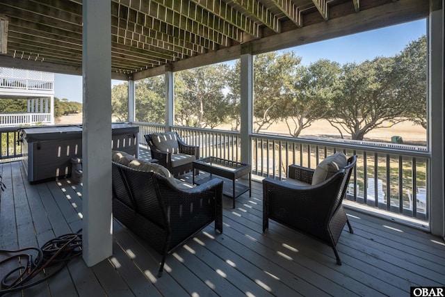 deck with a hot tub and an outdoor hangout area