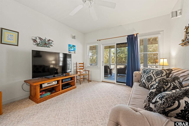 living area with carpet, baseboards, and ceiling fan