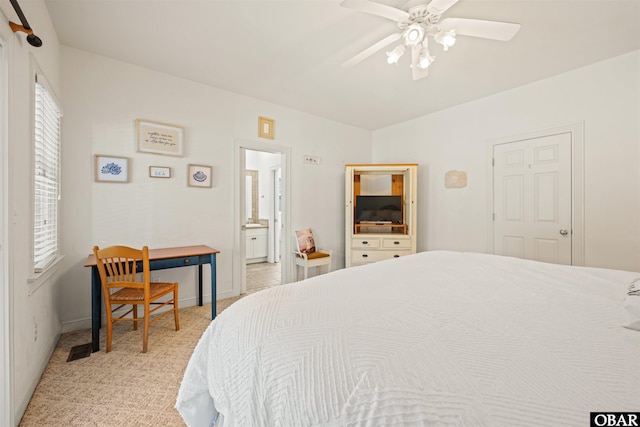 bedroom featuring visible vents, a ceiling fan, connected bathroom, baseboards, and light colored carpet