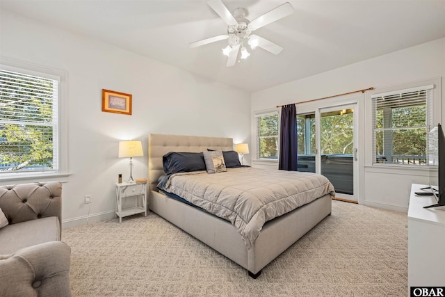 carpeted bedroom featuring access to exterior, a ceiling fan, and baseboards