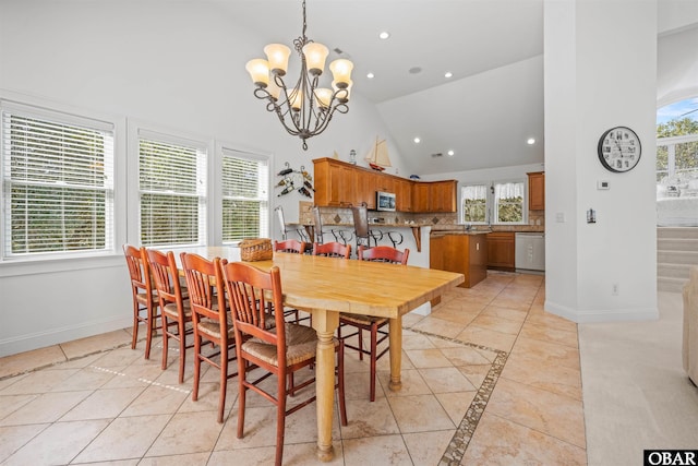 dining room featuring a notable chandelier, recessed lighting, high vaulted ceiling, and baseboards