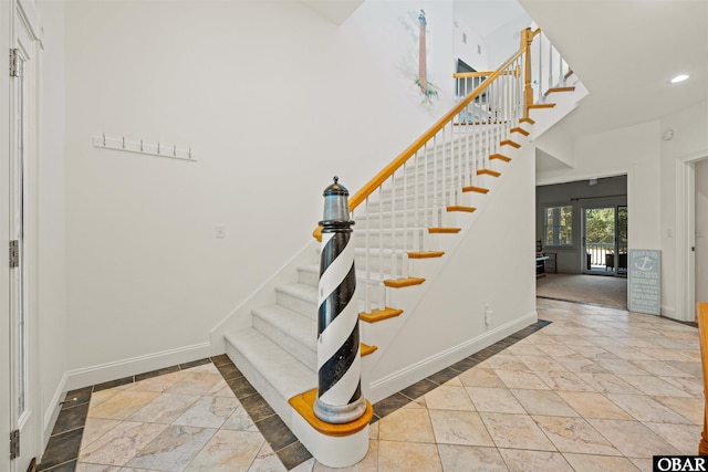 stairs featuring recessed lighting and baseboards