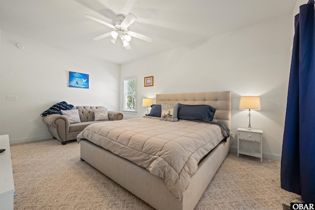 carpeted bedroom with a ceiling fan and baseboards