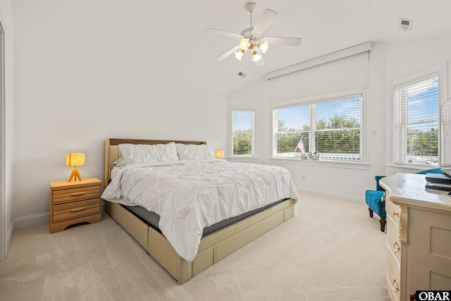 bedroom featuring visible vents, light carpet, baseboards, ceiling fan, and vaulted ceiling