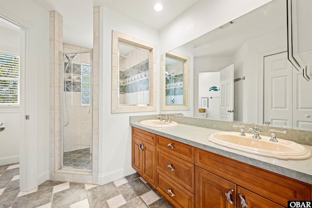 full bath featuring double vanity, visible vents, a stall shower, and a sink