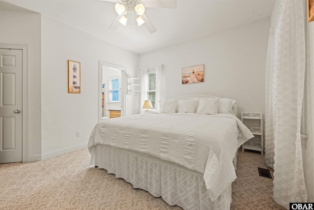 carpeted bedroom featuring visible vents, a ceiling fan, and baseboards