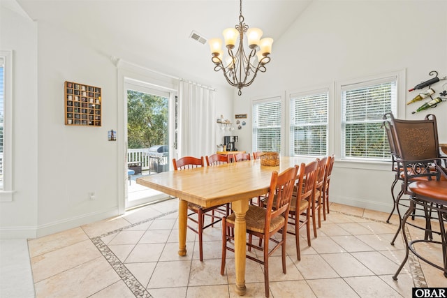 dining space with light tile patterned floors, visible vents, a chandelier, and baseboards