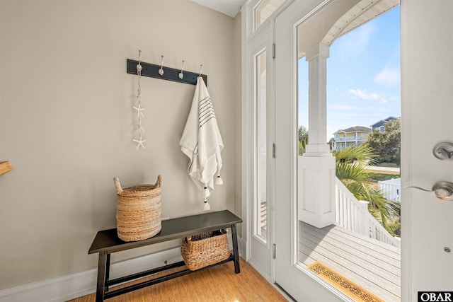 mudroom with baseboards and light wood-style flooring